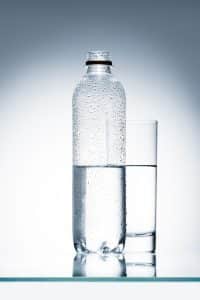 A bottle and glass of water