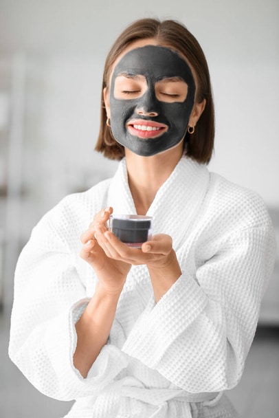 what is a charcoal Young woman with activated charcoal mask