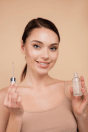 a women holding a Hyaluronic Acid serum bottle